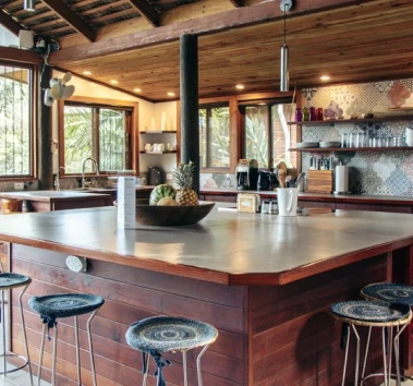 Casa Botanica wooden villa exterior surrounded by lush tropical island greenery